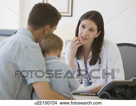 Picture - Female doctor talking to father and son. Fotosearch