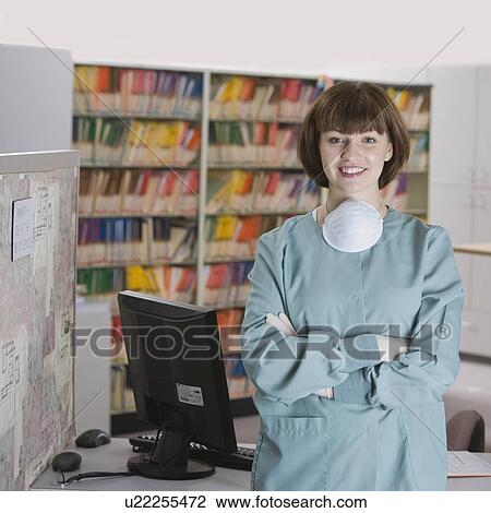 Stock Image - Female doctor with arms crossed. Fotosearch