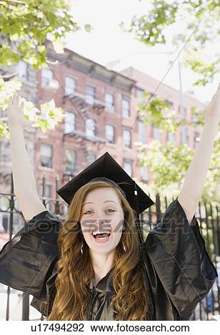 Stock Image - Female graduate celebrating. Fotosearch
