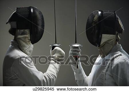 Stock Photography - Fencers in masks facing off with fencing foils. Fotosearch