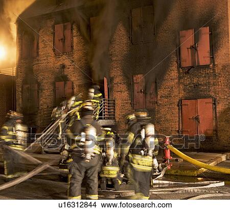 Picture - Firefighters at burning building. Fotosearch