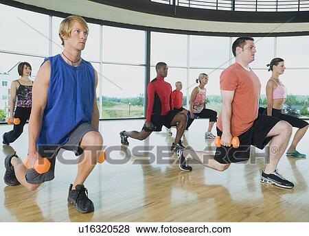 Fitness class doing lunges with dumbbells View Large Photo Image Stock Photo - Fitness class doing lunges with dumbbells. Fotosearch