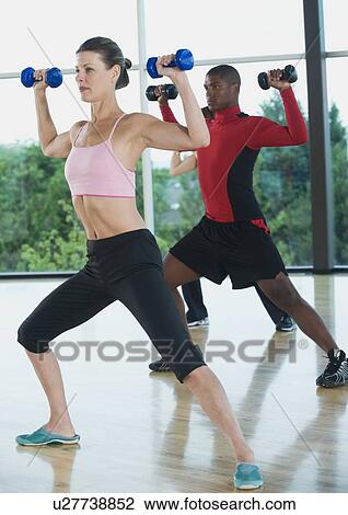 Fitness class doing shoulder presses with dumbbells View Large Photo Image Stock Image - Fitness class doing shoulder presses with dumbbells. Fotosearch