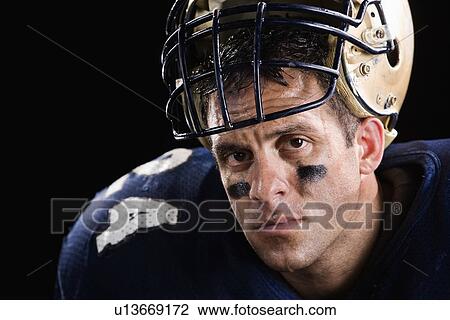 Stock Image - Football player looking serious. Fotosearch