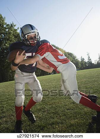 Football player tackling opponent View Large Photo Image Picture - Football player tackling opponent. Fotosearch