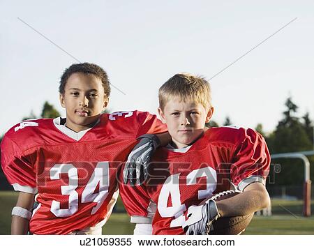 Football players posing on field View Large Photo Image Stock Photography - Football players posing on field. Fotosearch