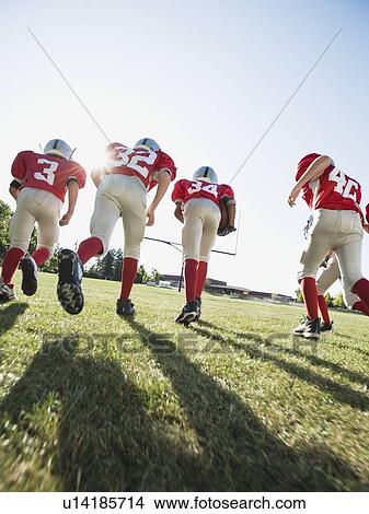 Football players running onto field View Large Photo Image Picture - Football players running onto field. Fotosearch