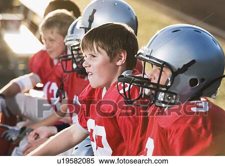 Stock Photography - Football players sitting on bench. Fotosearch