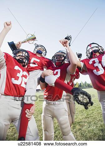 Football team with trophy celebrating View Large Photo Image Stock Photo - Football team with trophy celebrating. Fotosearch
