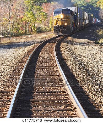 Stock Photograph - Freight train moving down tracks. Fotosearch
