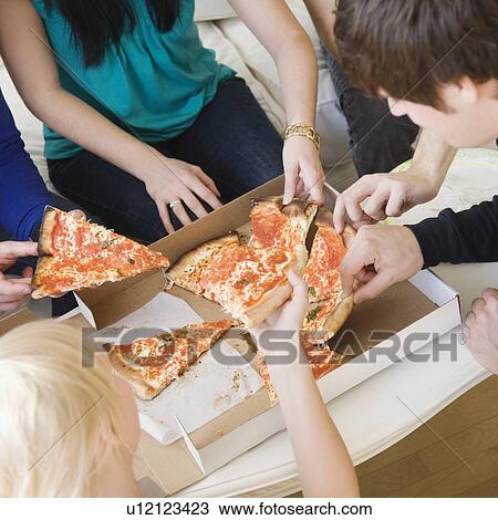 Stock Image - Friends eating pizza. Fotosearch