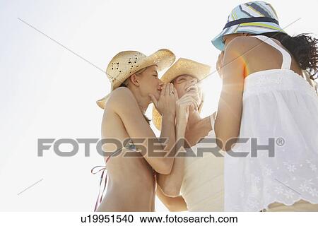 Stock Image - Friends gossiping on beach. Fotosearch