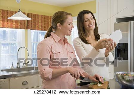 Friends preparing dinner View Large Photo Image Stock Image - Friends preparing dinner. Fotosearch