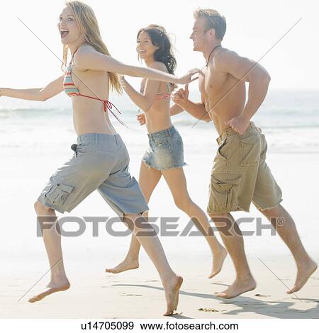 Friends running on beach View Large Photo Image Stock Photo - Friends running on beach. Fotosearch