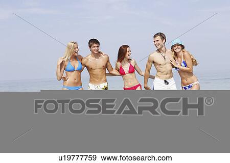 Friends wading in ocean View Large Photo Image Stock Photo - Friends wading in ocean. Fotosearch