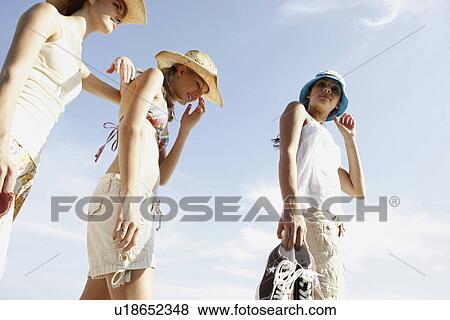 Stock Photo - Friends walking in beach. Fotosearch