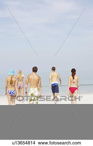 Picture - Friends walking on beach. Fotosearch