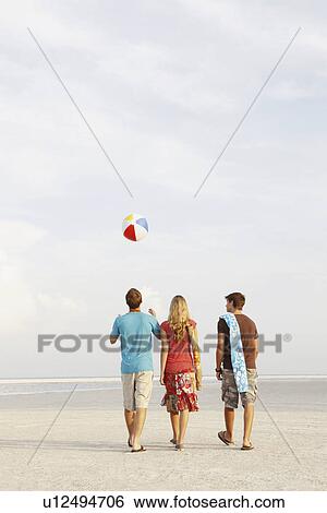 Friends walking on beach View Large Photo Image Stock Photograph - Friends walking on beach. Fotosearch