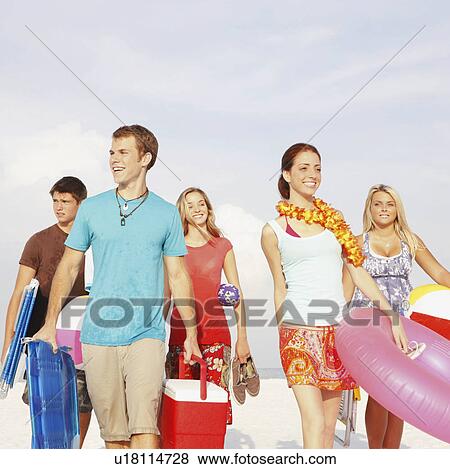 Friends walking with beach essentials View Large Photo Image Stock Photo - Friends walking with beach essentials. Fotosearch