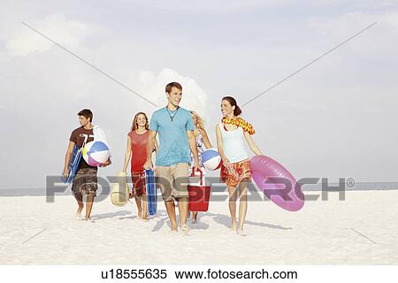 Friends walking with beach essentials View Large Photo Image Stock Photography - Friends walking with beach essentials. Fotosearch