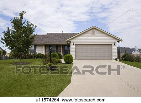 Front view of house with garage View Large Photo Image Picture - Front view of house with garage. Fotosearch