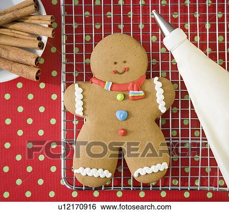 Gingerbread man cookie on cooling rack View Large Photo Image Stock Photograph - Gingerbread man cookie on cooling rack. Fotosearch