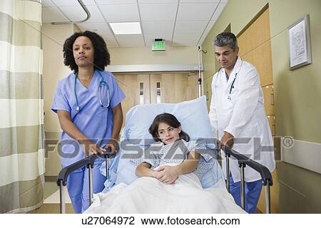 Girl being wheeling in hospital gurney View Large Photo Image Stock Image - Girl being wheeling in hospital gurney. Fotosearch