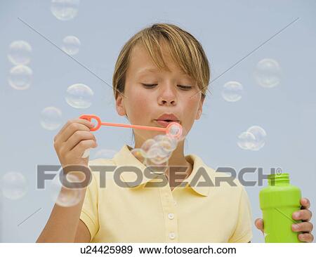 Stock Photo - Girl blowing bubbles. Fotosearch