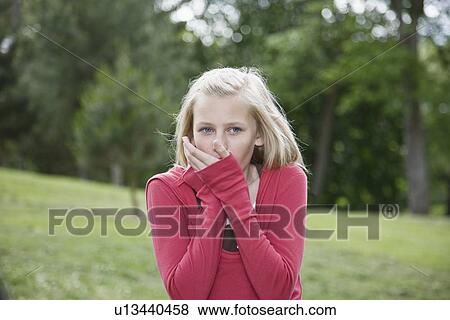 Girl blowing on cold hands View Large Photo Image Stock Photo - Girl blowing on cold hands. Fotosearch