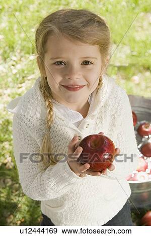 Stock Photo - Girl bobbing for apples. Fotosearch