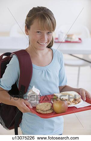 Girl carrying lunch tray in school cafeteria View Large Photo Image Stock Photograph - Girl carrying lunch tray in school cafeteria. Fotosearch