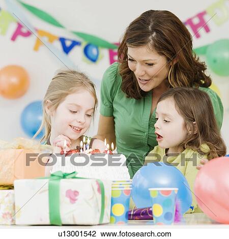 Girl celebrating birthday with mother and sister View Large Photo Image Stock Image - Girl celebrating birthday with mother and sister. Fotosearch