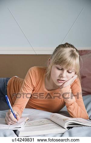 Girl doing homework on bed View Large Photo Image Stock Image - Girl doing homework on bed. Fotosearch