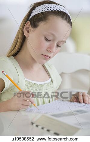 Stock Image - Girl doing homework. Fotosearch