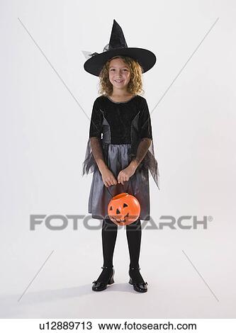 Girl dressed in witch Halloween costume View Large Photo Image Stock Image - Girl dressed in witch Halloween costume. Fotosearch