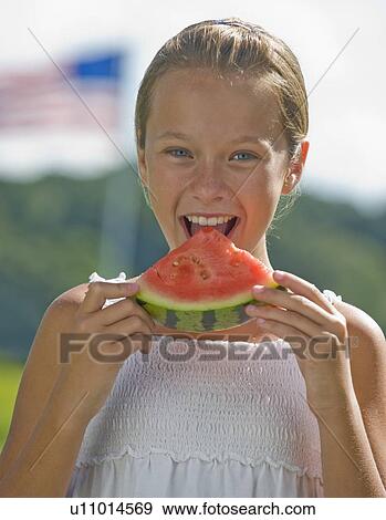 Girl eating watermelon outdoors View Large Photo Image Stock Photo - Girl eating watermelon outdoors. Fotosearch