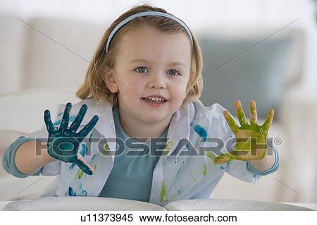 Stock Photography - Girl finger painting with different colors. Fotosearch