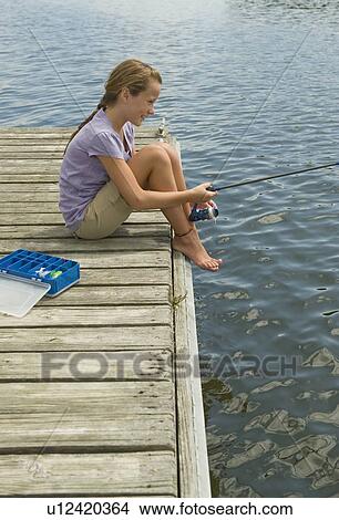 Picture - Girl fishing off dock. Fotosearch
