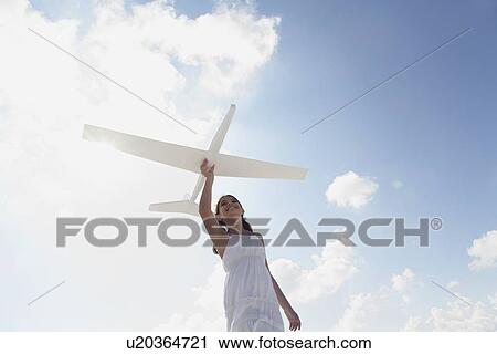 Girl flying model airplane View Large Photo Image Stock Image - Girl flying model airplane. Fotosearch