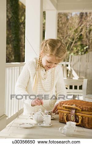 Girl having tea party on porch View Large Photo Image Stock Image - Girl having tea party on porch. Fotosearch
