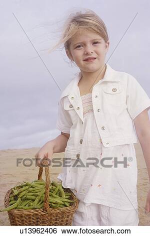 Girl holding basket of green beans View Large Photo Image Stock Photograph - Girl holding basket of green beans. Fotosearch