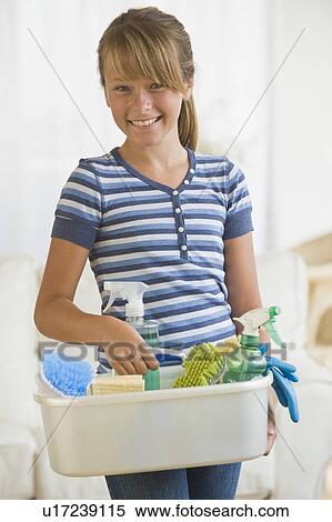 Stock Photography - Girl holding bucket of cleaning supplies. Fotosearch