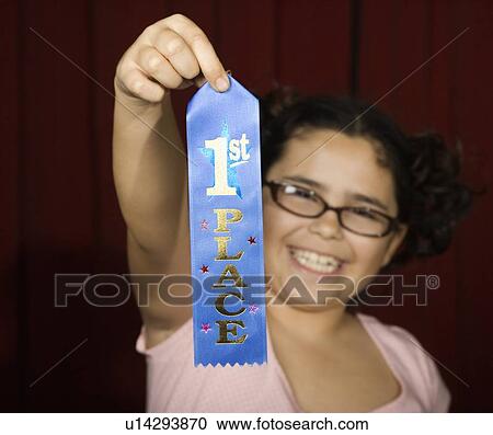 Girl holding first place ribbon on stage View Large Photo Image Stock Image - Girl holding first place ribbon on stage. Fotosearch