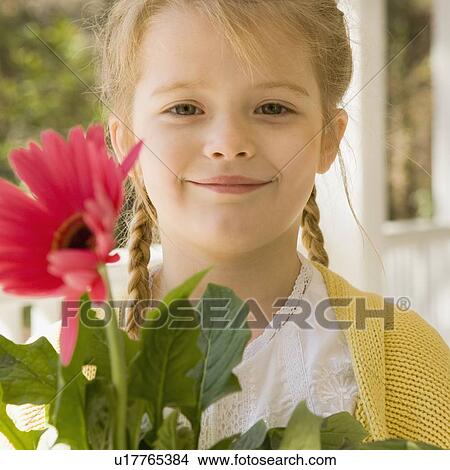 Girl holding flower View Large Photo Image Picture - Girl holding flower. Fotosearch