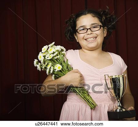 Girl holding flowers and trophy View Large Photo Image Stock Image - Girl holding flowers and trophy. Fotosearch