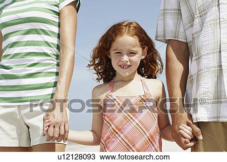 Girl holding hands with mother and father View Large Photo Image Stock Image - Girl holding hands with mother and father. Fotosearch