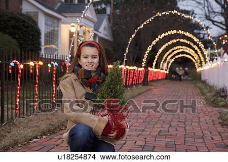 Girl holding potted plant View Large Photo Image Picture - Girl holding potted plant. Fotosearch