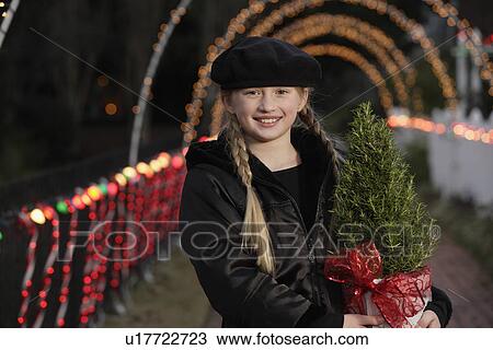 Girl holding potted plant View Large Photo Image Stock Image - Girl holding potted plant. Fotosearch
