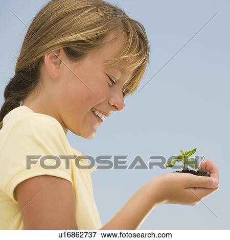 Stock Photo - Girl holding seedling. Fotosearch