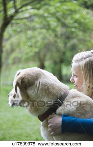 Girl hugging dog in park View Large Photo Image Stock Photography - Girl hugging dog in park. Fotosearch